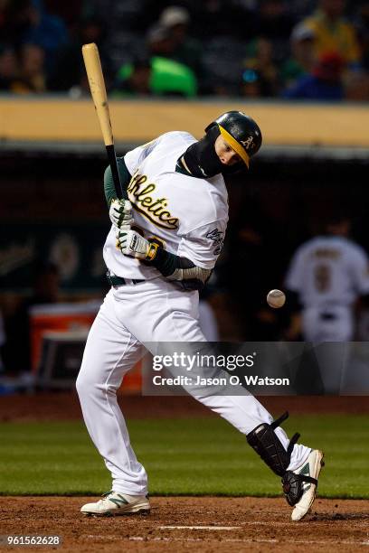 Mark Canha of the Oakland Athletics is hit by a pitch from Mike Leake of the Seattle Mariners during the fifth inning at the Oakland Coliseum on May...