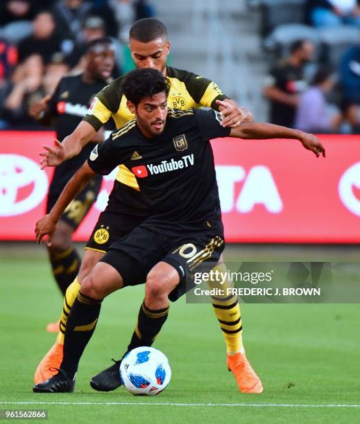 Carlos Vela of LAFC vies for the ball with Jeremy Toljan of Borussia Dortmund during their international soccer friendly in Los Angeles, California...