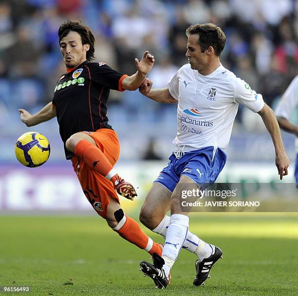 Valencia's midfielder David Silva fights for the ball with Tenerife's midfielder Mikel Alonso during their Spanish league football match at the...