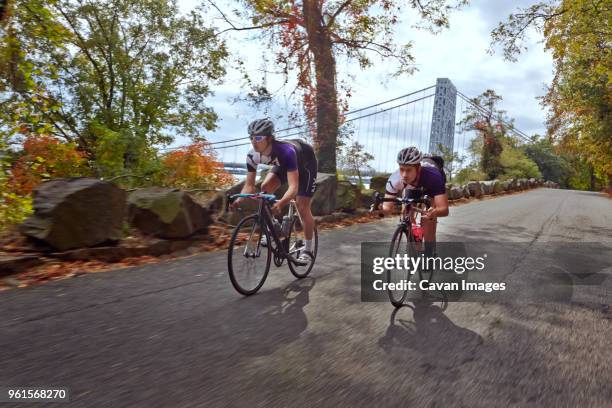 cyclists racing on bicycle by george washington bridge - george washington bridge bildbanksfoton och bilder