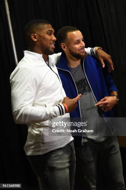 Anthony Joshua and Stephen Curry of the Golden State Warriors after the game against the Houston Rockets in Game Four of the Western Conference...