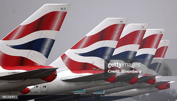 The tail fins of British Airways aircraft are seen at Terminal 5 at Heathrow airport in London, U.K., on Monday, Jan. 25, 2010. British Airways Plc...