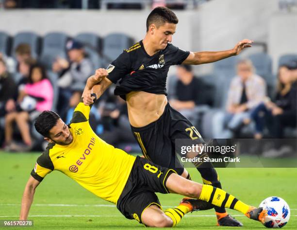 Nuri Sahin of Borussia Dortmund defends against Maximilian Philipp of Los Angeles FC during Los Angeles FC's friendly match against Borussia Dortmund...