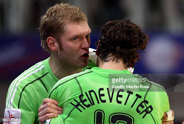 Johannes Bitter of Germany speaks to team mate Silvio Heinevetter during the Men's Handball European Championship Group C match between Germany and...