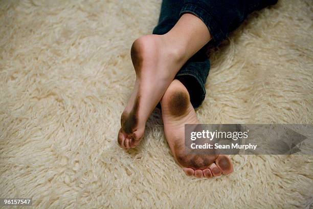 little boy with dirty feet - fur rug stock pictures, royalty-free photos & images