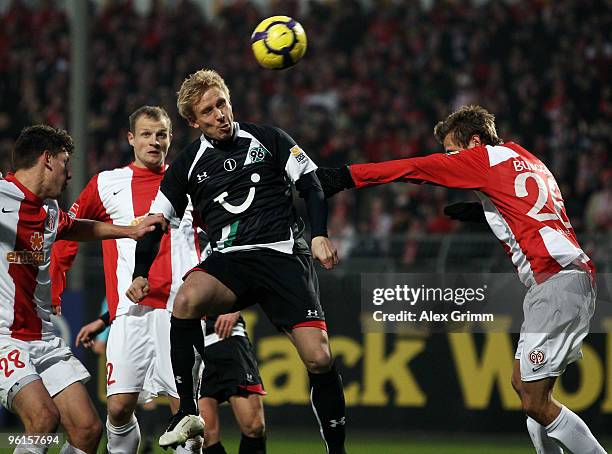 Mike Hanke of Hannover is challenged by Adam Szalai , Bo Svensson and Niko Bungert of Mainz during the Bundesliga match between FSV Mainz 05 and...