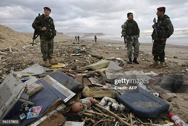 Lebanese soldiers stand near debris and personal belongings of passengers aboard an Ethiopian airliner that washed up on the shores of the Lebanese...