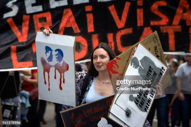 Student in arts holds several placards. More than 10.000 protestors take to the streets of Toulouse for the 3rd time in a show of defiance towards...