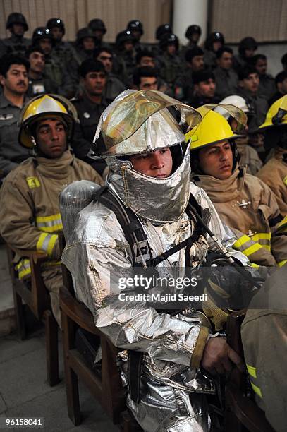 Afghan fire fighters attend a thanks-giving ceremony for Afghan policemen who fought against Taliban fighters during the January 18 attack in the...