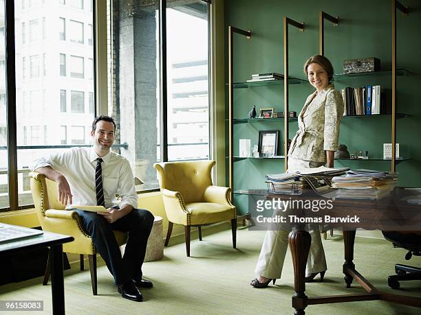 portrait of two businesspeople in office - leanintogether stock pictures, royalty-free photos & images