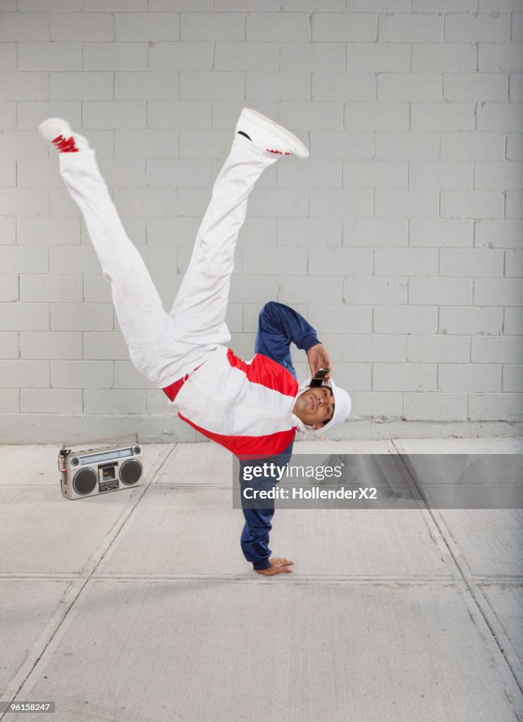 Man on phone while breakdancing