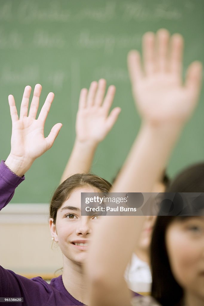 High-school students raising hands