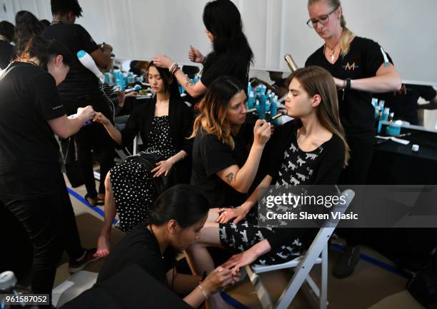 Models prepare backstage at Oscar De La Renta Resort 2019 Runway Show at Academy Mansion on May 22, 2018 in New York City.