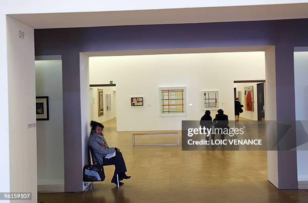 People look at paintings by Dutch artist Piet Mondrian shown in the permanent collection of the national Modern Art Museum at the Georges Pompidou...