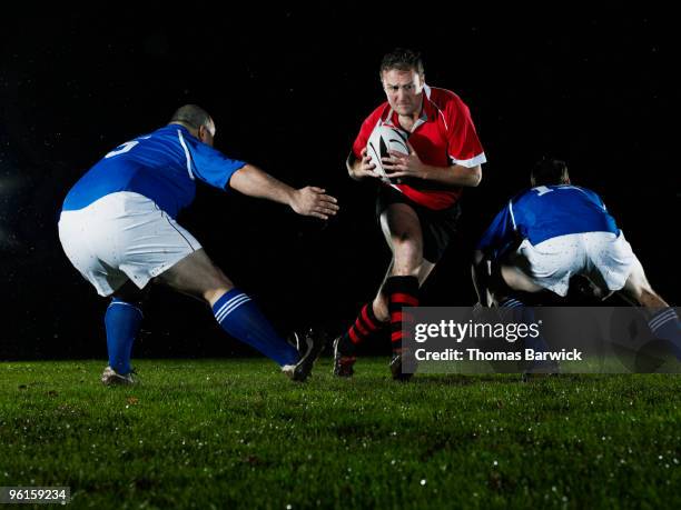 rugby player avoiding opposing team - rugby tackling stock pictures, royalty-free photos & images