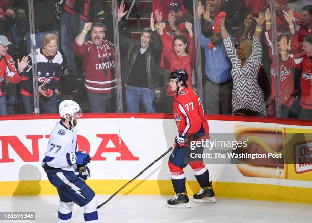 Washington Capitals fans celebrate after T.J. Oshie scored an empty netter in the third period against the Tampa Bay Lightning during game six of the...