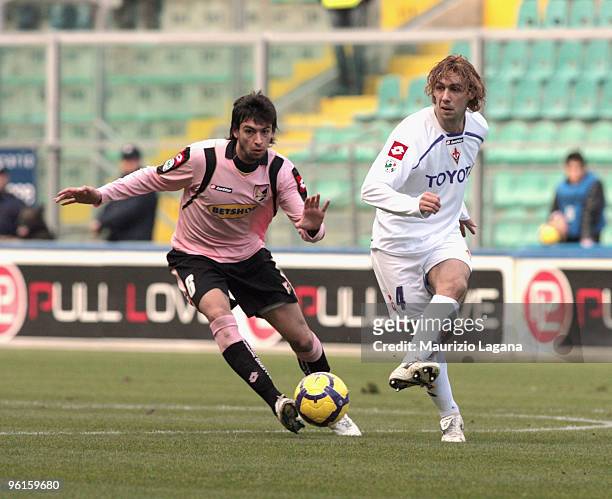 Javier Pastore of Palermo is challenged by Marco Donadel of Fiorentina during the Serie A match between Palermo and Fiorentina at Stadio Renzo...