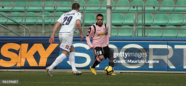 Fabrizio Miccoli of Palermo is challenged by Lorenzo De Silvestri of Fiorentina during the Serie A match between Palermo and Fiorentina at Stadio...