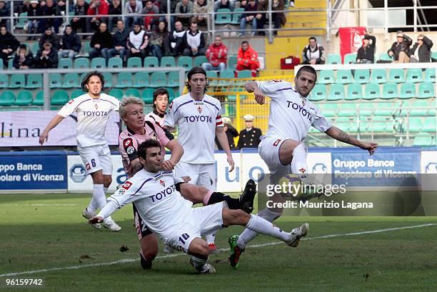 Simon Kjaer of Palermo is challenged by Adrian Mutu and Alessandro Gamberini of Fiorentina during the Serie A match between Palermo and Fiorentina at...