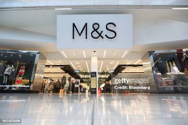 Signs stands above the entrance to a branch of Marks & Spencer Group Plc in London, U.K., on Tuesday, Dec. 5, 2017. A decline in sales of food and...