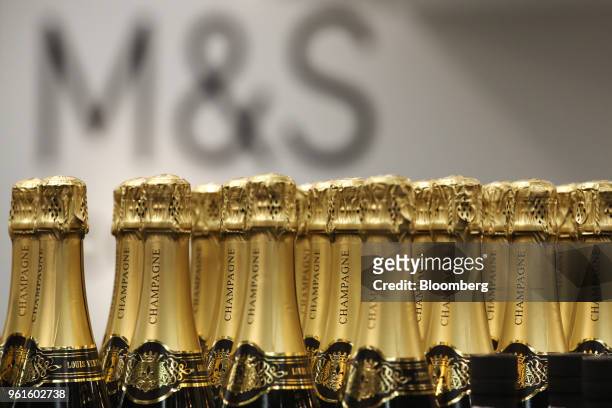 Bottles of champagne stand on display in the food hall inside a branch of Marks & Spencer Group Plc in London, U.K., on Tuesday, Dec. 5, 2017. A...