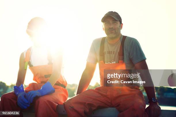 portrait of fishermen sitting at trawler - portrait fisherman stock-fotos und bilder