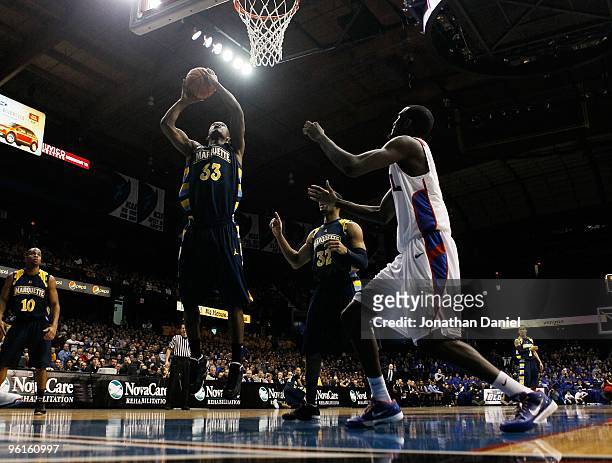 Jimmy Butler of the Marquette Golden Eagles shoots against Devin Hill of the DePaul Blue Demons at the Allstate Arena on January 20, 2010 in...