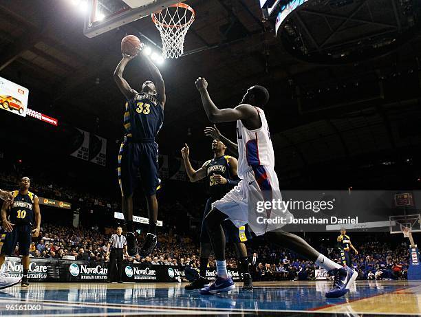 Jimmy Butler of the Marquette Golden Eagles shoots against Devin Hill of the DePaul Blue Demons at the Allstate Arena on January 20, 2010 in...