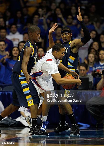 Mike Stovall of the DePaul Blue Demons moves between Jimmy Butler and Lazar Hayward of the Marquette Golden Eagles at the Allstate Arena on January...