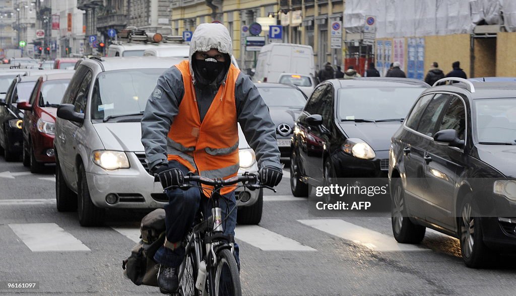A man wears a protective mask as he ride