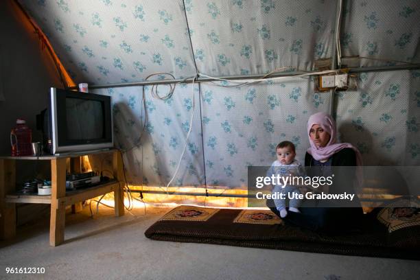 April 23: A young woman with her five-month-old child in her 24 square meter tent in the refugee camp Kabarto 2 in the District Semeel on April 23,...