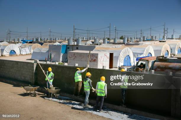 April 23: Construction workers build a wall around the refugee camp Kabarto 2 in the district Semeel on April 23, 2018 in DOHUK, IRAQ. The german...