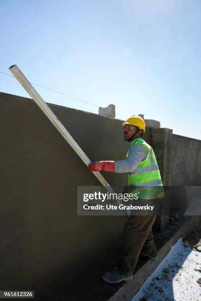 April 23: A construction worker builds a wall around the refugee camp Kabarto 2 in the district Semeel on April 23, 2018 in DOHUK, IRAQ. The german...