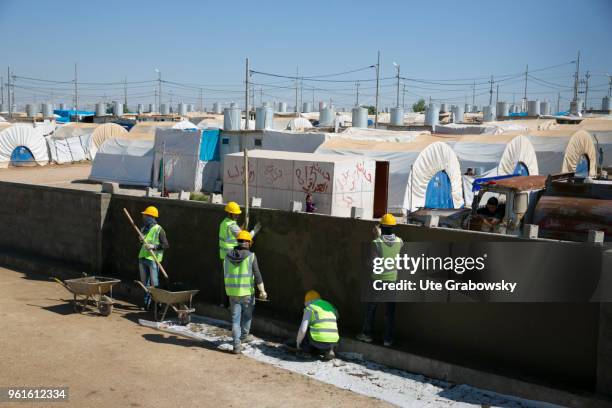 April 23: Construction workers build a wall around the refugee camp Kabarto 2 in the district Semeel on April 23, 2018 in DOHUK, IRAQ. The german...