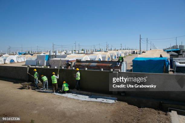 April 23: Construction workers build a wall around the refugee camp Kabarto 2 in the district Semeel on April 23, 2018 in DOHUK, IRAQ. The german...