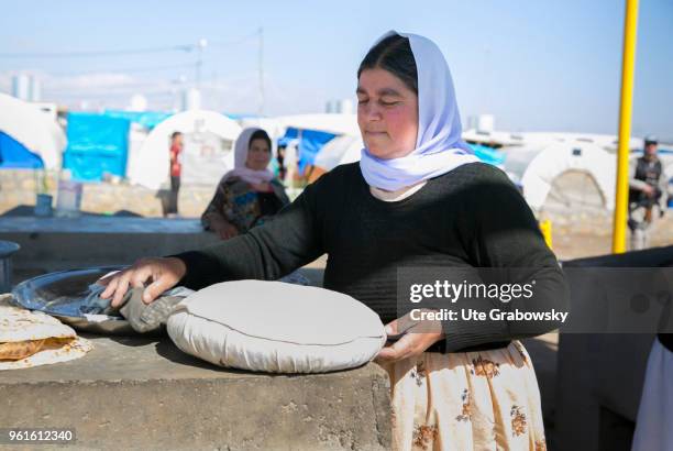 April 23: A woman bakes traditional bread in the refugee camp Kabarto 2 in the district Semeel on April 23, 2018 in DOHUK, IRAQ.