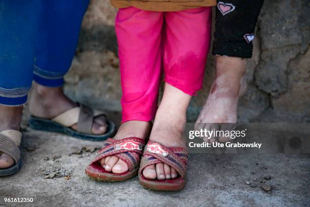April 23: Feet of three little girls in the refugee camp Kabarto 2 in the District Semeel on April 23, 2018 in DOHUK, IRAQ.