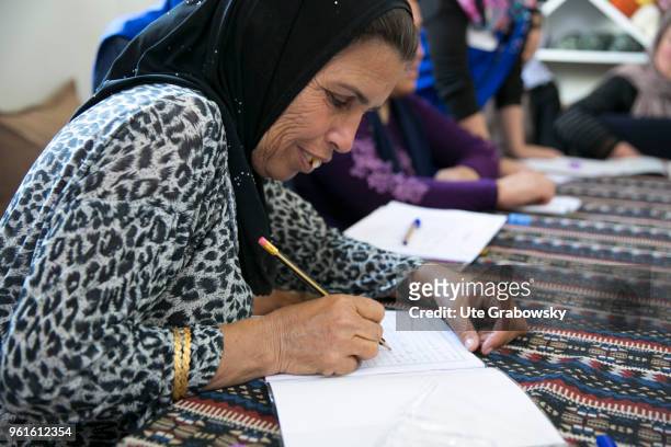 April 23: Refuge Camp Kabarto 2 in District Semeel. Yazidi and Muslim women who attend literacy classes write in a practice booklet on April 23, 2018...