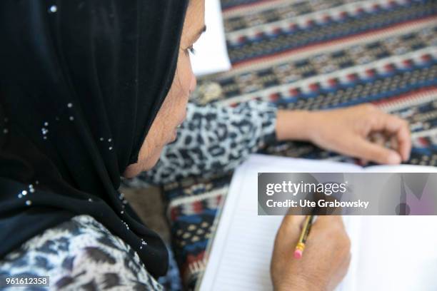 April 23: Refuge Camp Kabarto 2 in District Semeel. Here Yazidi and Muslim women can participate in literacy classes. Close-up of a senior woman...