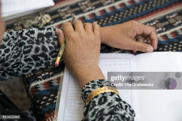 April 23: Refuge Camp Kabarto 2 in District Semeel. Here Yazidi and Muslim women can participate in literacy classes. Close-up of a senior woman...