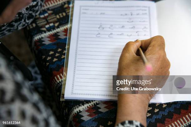 April 23: Refuge Camp Kabarto 2 in District Semeel. Here Yazidi and Muslim women can participate in literacy classes. Close-up of a senior woman...