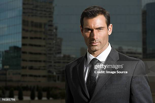 portrait of a businessman against a city background - striped suit stock pictures, royalty-free photos & images