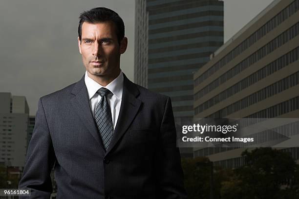 portrait of a businessman against a city background - striped suit stock pictures, royalty-free photos & images