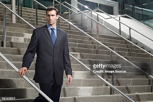 a businessman descending a staircase - baltimore convention center stock pictures, royalty-free photos & images