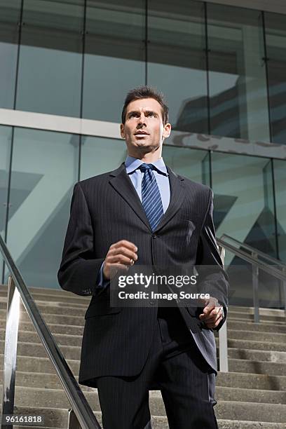 a business man running down a steps - baltimore convention center stock pictures, royalty-free photos & images