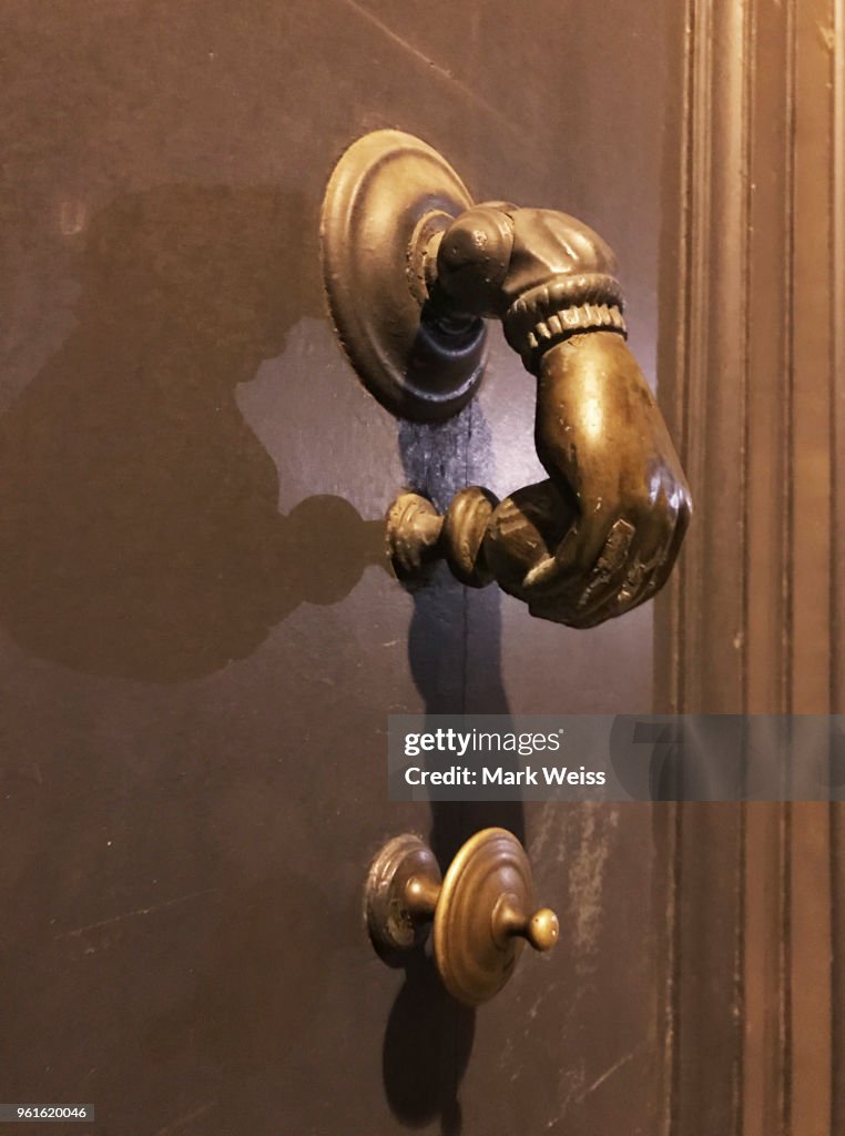 Close up of brass Fatima's hand door knocker in Bordeaux, France