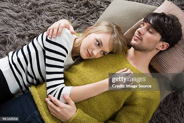 young couple lying down - cushion top view stock pictures, royalty-free photos & images