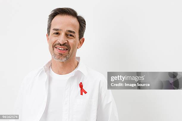 man wearing aids awareness ribbon - aids awareness ribbon stock pictures, royalty-free photos & images