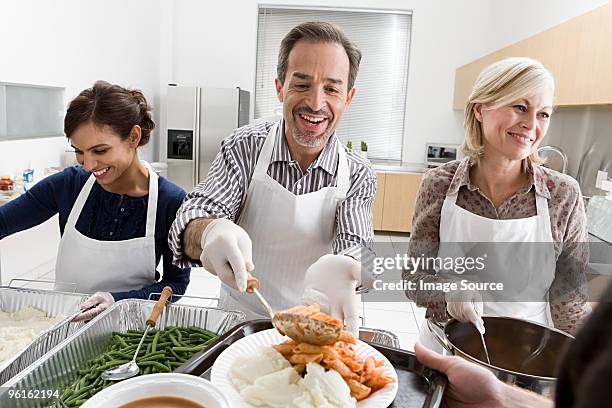 people volunteering at soup kitchen - soup kitchen stock pictures, royalty-free photos & images