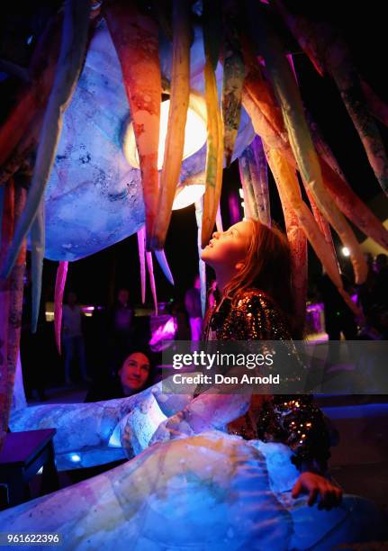 Eva Milkovic gazes into the eyes of the puppet creature named Marri Dyin during a media preview for Vivid Sydney on May 23, 2018 in Sydney,...